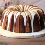 A whole Dulce de Leche Vanilla Bean Pound Cake drizzled with vanilla cream cheese glaze and dulce de leche.